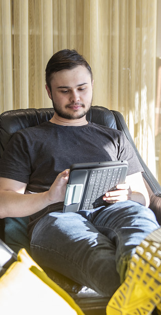 Young man working with a tablet.