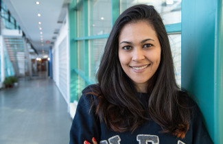 Young woman looking at the camera smiling.