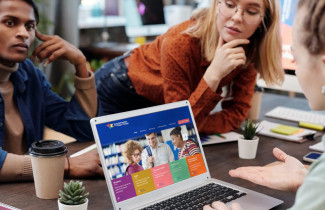 Students having a chat by laptop.