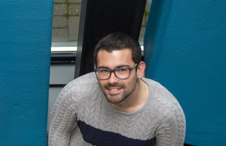 Student wearing glasses and smiling