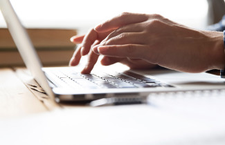 Laptop computer and hands.