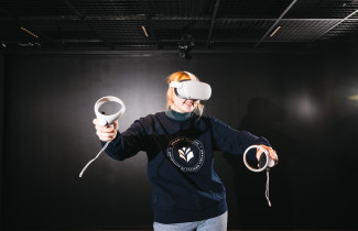 Nainen pelaamassa virtuaalitodellisuudessa.