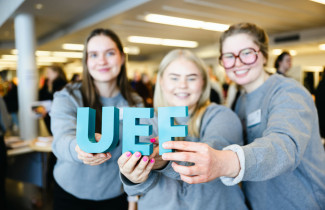 Persons are holding UEF letters in their hands.