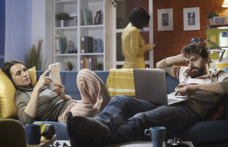 Friends connecting with their devices at home and ignoring each other, technology and lifestyle concept.