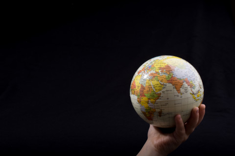 Hand holding a globe