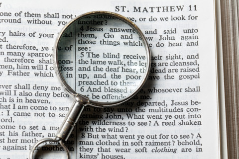 magnifying glass on a book.
