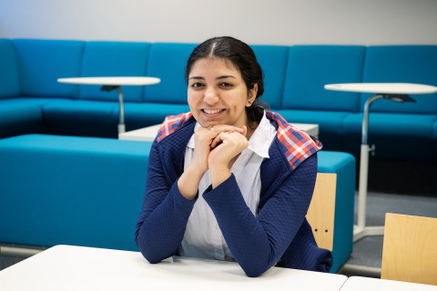 Young woman looking at the camera smiling.