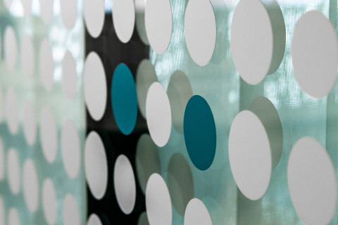 Round stickers on glass wall.