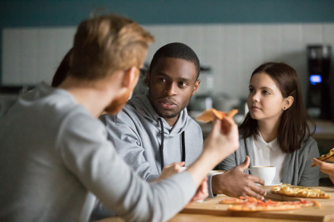 Young adults eating pizza