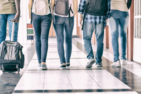 Teenagers in school hallway.
