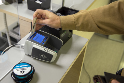 A person is paying fines and fees