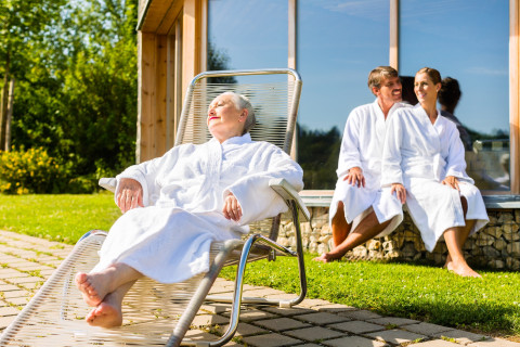 People relaxing outside sauna.