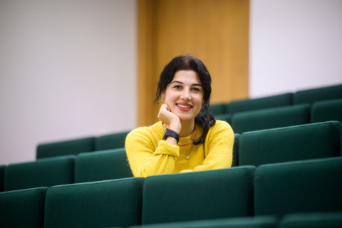 Student sitting in lecture and smiling