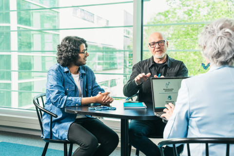 kolme ihmistä keskustelevat