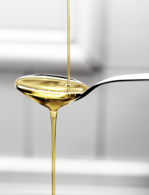 Plant-based oil being poured onto a spoon.