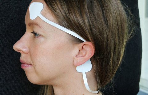 Woman with a wearable sensor on her head.