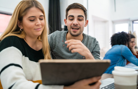 Two people working together.