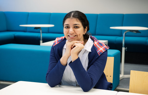 Young woman looking at the camera smiling.