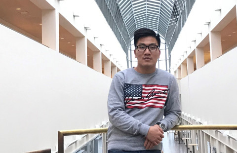 Young man with short dark hair looking at the camera.
