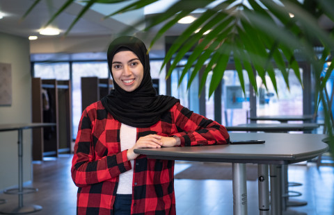 Young woman looking at the camera smiling.