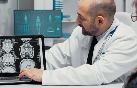 Doctor explaining brain scan results to a patient.