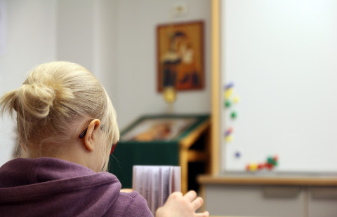 Girl is reading Bible.