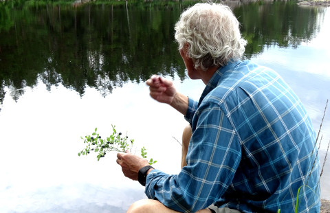 Man eating blueberries.