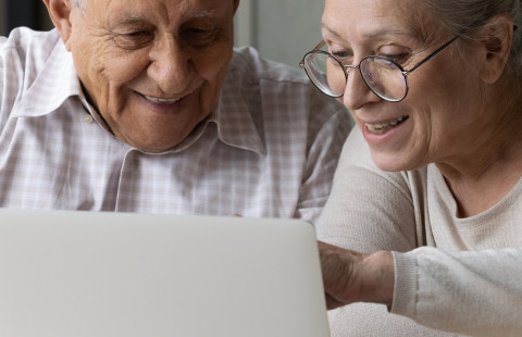 Old man and woman on a computer.