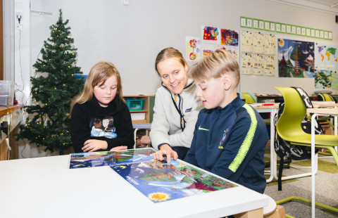 Oppilaat arvioimassa itseään opettajan kanssa.