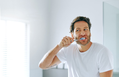 Person brushing teeth.
