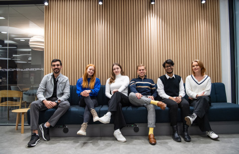 Students sitting on a bench and smiling