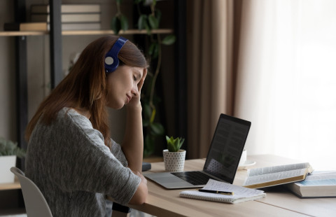 Nainen tekee opiskelee kotona.