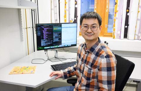 Lu Cheng working on a computor.