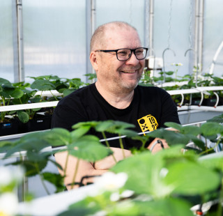 Researcher Harri Kokko photographed in the greenhouse on the roof of Melania.