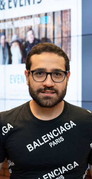 Young man with glasses looking straight to the camera.