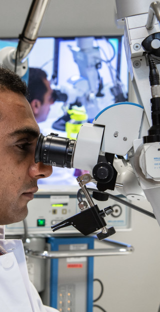 Man working with a microscope.