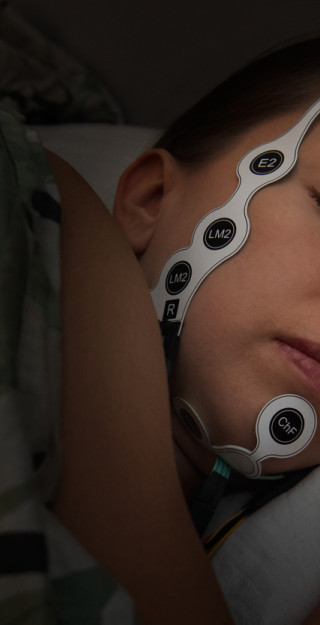 Sensors fixed on a sleeping womans head.