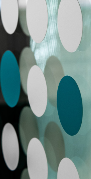 Round stickers on glass wall.