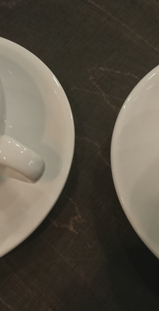 Two white coffee cups with desoration figures on the cream foam